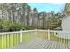 The backyard deck offers an outdoor living space and view of the wooded area at 5880 April Dr, Sugar Hill, GA 30518