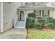 Inviting front entrance with a decorative door and landscaped bushes at 5880 April Dr, Sugar Hill, GA 30518
