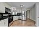 Modern kitchen features stainless steel appliances, granite countertops, and ample storage at 5880 April Dr, Sugar Hill, GA 30518