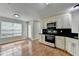 Open kitchen area features white cabinets and flows into a dining space with natural light at 5880 April Dr, Sugar Hill, GA 30518