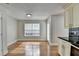 Cozy kitchen area with hardwood flooring, white cabinets, and a view to the outside at 5880 April Dr, Sugar Hill, GA 30518