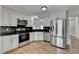 Spacious kitchen featuring modern appliances, granite countertops, and ample cabinet space at 5880 April Dr, Sugar Hill, GA 30518
