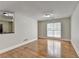 Bright living room featuring hardwood floors and a large window for natural light at 5880 April Dr, Sugar Hill, GA 30518