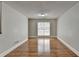 Bright living room with hardwood floors, neutral walls, and a sliding glass door for outdoor access at 5880 April Dr, Sugar Hill, GA 30518