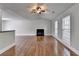 Bright living room showcasing hardwood floors, a fireplace, and neutral paint at 5880 April Dr, Sugar Hill, GA 30518