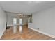 Open-concept living room featuring hardwood floors, a fireplace, and natural light at 5880 April Dr, Sugar Hill, GA 30518