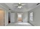 Spacious main bedroom with tray ceiling, fan, and ensuite bathroom at 5880 April Dr, Sugar Hill, GA 30518