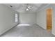 Spacious main bedroom with tray ceiling, fan, and walk-in closet at 5880 April Dr, Sugar Hill, GA 30518