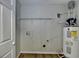 The utility room includes shelving, a water heater, and a dryer hookup at 5880 April Dr, Sugar Hill, GA 30518