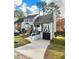 Inviting two-story home with a well-maintained lawn and a paved driveway leading to an attached garage at 1118 Magnolia Se Way, Smyrna, GA 30082