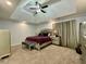 Elegant main bedroom featuring a tray ceiling, plush carpet, and tasteful decor at 1118 Magnolia Se Way, Smyrna, GA 30082