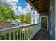 A covered balcony offers a view of mature trees and the surrounding neighborhood at 1602 Gettysburg Pl, Sandy Springs, GA 30350