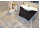 Stylish bathroom featuring polka dot tile flooring, a dark vanity, a white sink, a toilet, and a bathtub at 1602 Gettysburg Pl, Sandy Springs, GA 30350