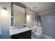 Bathroom with a vanity, large mirror, and a shower/tub combination with a neutral curtain at 1602 Gettysburg Pl, Sandy Springs, GA 30350
