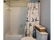 Cozy bathroom with bathtub, white tile walls, and a starfish-themed shower curtain at 1602 Gettysburg Pl, Sandy Springs, GA 30350