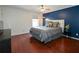 Primary bedroom featuring hardwood floors, a ceiling fan, and a queen-sized bed at 1602 Gettysburg Pl, Sandy Springs, GA 30350