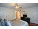 This bedroom features a ceiling fan and a dresser with a tv, providing a comfortable and modern space at 1602 Gettysburg Pl, Sandy Springs, GA 30350