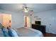 This bedroom features a ceiling fan and a dresser with a tv, providing a comfortable and modern space at 1602 Gettysburg Pl, Sandy Springs, GA 30350