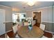 Dining room featuring an elegant table, a mirrored wall, and a view to kitchen and living area at 1602 Gettysburg Pl, Sandy Springs, GA 30350