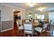 Dining room with a view of the kitchen, a mirrored wall, and hardwood floors at 1602 Gettysburg Pl, Sandy Springs, GA 30350