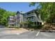 Multi-level condo building shows three stories and balconies, as well as parking and landscaping at 1602 Gettysburg Pl, Sandy Springs, GA 30350