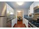 Well-lit kitchen with stainless steel appliances, granite countertops, and access to a dining room at 1602 Gettysburg Pl, Sandy Springs, GA 30350