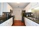 Modern kitchen features white cabinets, black countertops, and stainless steel appliances at 1602 Gettysburg Pl, Sandy Springs, GA 30350