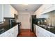 Modern kitchen features white cabinets, black countertops, and stainless steel appliances at 1602 Gettysburg Pl, Sandy Springs, GA 30350