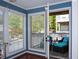 A covered porch features ample sunlight, comfortable furniture, and views of the neighborhood at 1602 Gettysburg Pl, Sandy Springs, GA 30350