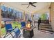 Inviting covered back patio with a fire pit, a ceiling fan, and comfortable seating at 262 Royal Crescent Ter, Canton, GA 30115