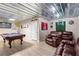 Finished basement with a pool table, seating area, and a drop ceiling at 262 Royal Crescent Ter, Canton, GA 30115