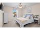 Bright bedroom with a cozy bed, a ceiling fan, and a sunny window view at 262 Royal Crescent Ter, Canton, GA 30115