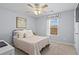 Cozy bedroom with a ceiling fan, natural light, and neutral tones at 262 Royal Crescent Ter, Canton, GA 30115