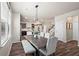 Dining room with a view to the kitchen, features a large dining table and bench-style seating at 262 Royal Crescent Ter, Canton, GA 30115
