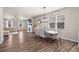Dining space with large windows, decorative lighting, and hardwood floors that lead to the living area at 262 Royal Crescent Ter, Canton, GA 30115