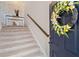 Inviting entryway with a decorative wreath on the door and a staircase leading to the upper level at 262 Royal Crescent Ter, Canton, GA 30115