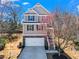 Charming two-story home with stone accents, a two-car garage, and a well-maintained front yard at 262 Royal Crescent Ter, Canton, GA 30115