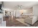 Open-concept living area with hardwood floors, comfortable seating, and a brick accent wall at 262 Royal Crescent Ter, Canton, GA 30115