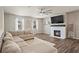 Bright living room featuring a modern fireplace, large sectional sofa, and ample natural light at 262 Royal Crescent Ter, Canton, GA 30115