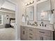 Spa-like bathroom with dual sinks, neutral vanities, and decorative mirrors at 262 Royal Crescent Ter, Canton, GA 30115