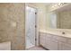 Well-lit bathroom with decorative wallpaper and white cabinetry at 591 Briarmeade Sw Dr, Marietta, GA 30064