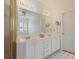 Bright bathroom with white cabinets, double sinks, and a large mirror at 591 Briarmeade Sw Dr, Marietta, GA 30064