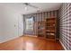 Spacious bedroom with hardwood floors, natural light, and plaid accent wall at 591 Briarmeade Sw Dr, Marietta, GA 30064