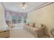 Bright bedroom with large windows and floral sofa seating area at 591 Briarmeade Sw Dr, Marietta, GA 30064