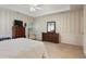 Neutral bedroom with a tray ceiling, a window, paneled walls, and two dressers at 591 Briarmeade Sw Dr, Marietta, GA 30064