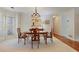Formal dining room with elegant chandelier, striped wallpaper and natural light from the windows at 591 Briarmeade Sw Dr, Marietta, GA 30064