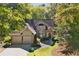 Charming two-story home with a two-car garage, a stone walkway, and mature trees at 591 Briarmeade Sw Dr, Marietta, GA 30064