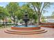 Downtown fountain with decorative benches and brick plaza and surrounding trees at 591 Briarmeade Sw Dr, Marietta, GA 30064