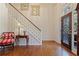 Bright foyer with hardwood floors, staircase with white railing, and decorative glass front door at 591 Briarmeade Sw Dr, Marietta, GA 30064