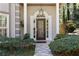 Close-up of the front door, highlighting its decorative glass and surrounding manicured landscaping at 591 Briarmeade Sw Dr, Marietta, GA 30064